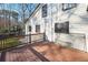 Exterior view of a house with a wooden deck and white siding and black trim windows at 4013 Brenteresa Ct, Snellville, GA 30039