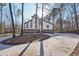 Modern home with stone accents and a circular driveway surrounded by trees at 4013 Brenteresa Ct, Snellville, GA 30039