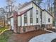 Striking exterior elevation of modern home featuring stone accents, tall windows, and a concrete driveway at 4013 Brenteresa Ct, Snellville, GA 30039
