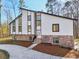 Contemporary home showcasing a unique roofline, bright siding, stone accents, and large windows for natural light at 4013 Brenteresa Ct, Snellville, GA 30039