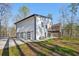 View of the home's garage and backyard featuring a screened-in porch and deck at 4013 Brenteresa Ct, Snellville, GA 30039