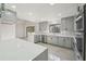 Modern kitchen with grey cabinets, black hardware, stainless steel appliances, marble backsplash, quartz countertops and recessed lighting at 4013 Brenteresa Ct, Snellville, GA 30039