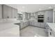 Modern kitchen with grey cabinets, black hardware, stainless steel appliances, marble backsplash, quartz countertops and recessed lighting at 4013 Brenteresa Ct, Snellville, GA 30039