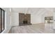 Open living room with a stone fireplace and sliding glass doors to the patio at 4013 Brenteresa Ct, Snellville, GA 30039