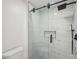 Walk-in shower with marble tile, a glass door, and a rainfall showerhead at 4013 Brenteresa Ct, Snellville, GA 30039