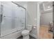 Bathroom featuring a shower-tub combo, toilet, and access to the bedroom at 1011 Nours Cir, Lawrenceville, GA 30045