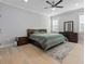 This bedroom boasts a ceiling fan, light hardwood floors, and ample natural light at 1011 Nours Cir, Lawrenceville, GA 30045