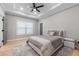 Bedroom with a tray ceiling, ceiling fan, and large window at 1011 Nours Cir, Lawrenceville, GA 30045