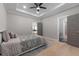 Bedroom featuring a trey ceiling, fan, hardwood floors, and ensuite access at 1011 Nours Cir, Lawrenceville, GA 30045