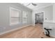 Bedroom with hardwood floors, large windows, and ensuite bathroom at 1011 Nours Cir, Lawrenceville, GA 30045