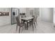 Dining area with modern table and chairs and stainless steel refrigerator at 1011 Nours Cir, Lawrenceville, GA 30045