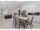 Open concept dining area with stainless steel appliances and modern table and chairs at 1011 Nours Cir, Lawrenceville, GA 30045