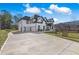 A paved driveway leads up to the front-facing garage of a light-colored, well-maintained home at 1011 Nours Cir, Lawrenceville, GA 30045