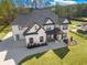 A elevated perspective of a home featuring a long driveway and a sprawling green lawn at 1011 Nours Cir, Lawrenceville, GA 30045