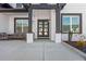 Elegant home entrance featuring a covered porch, brick accents, and a modern double-door entryway at 1011 Nours Cir, Lawrenceville, GA 30045