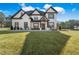 Beautiful home featuring a well-manicured lawn, a covered porch, and white and black trim at 1011 Nours Cir, Lawrenceville, GA 30045