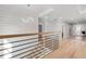 Hallway with a modern chandelier, shiplap accent walls and staircase with metal railings at 1011 Nours Cir, Lawrenceville, GA 30045