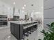A spacious, modern kitchen with a large island and marble floors, white cabinets and stainless steel appliances at 1011 Nours Cir, Lawrenceville, GA 30045