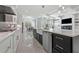 Kitchen features stainless steel appliances, white cabinets, and a large island with marble countertop at 1011 Nours Cir, Lawrenceville, GA 30045