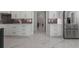 Modern kitchen with white cabinets, stainless steel appliances, and marble tile floor at 1011 Nours Cir, Lawrenceville, GA 30045