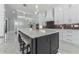 Modern kitchen with large island, stainless steel appliances, white cabinets, and marble floors at 1011 Nours Cir, Lawrenceville, GA 30045
