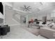Open-concept living room with marble floors, modern staircase, and view of kitchen at 1011 Nours Cir, Lawrenceville, GA 30045