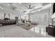 Spacious living room with an open floor plan showing the modern kitchen and bright marble floors at 1011 Nours Cir, Lawrenceville, GA 30045