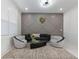 Modern living room with stylish decor, including patterned chairs and unique accent wall at 1011 Nours Cir, Lawrenceville, GA 30045
