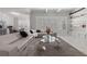 Open-concept living area with marble floors, modern sofa, and view of the dining area at 1011 Nours Cir, Lawrenceville, GA 30045