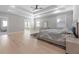 Main bedroom featuring a tray ceiling, hardwood floors, and ensuite bathroom at 1011 Nours Cir, Lawrenceville, GA 30045