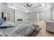 Main bedroom featuring a tray ceiling, fireplace, hardwood floors, and ensuite bathroom at 1011 Nours Cir, Lawrenceville, GA 30045