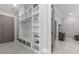 Mudroom with built-in shelving and seating and access to the garage at 1011 Nours Cir, Lawrenceville, GA 30045