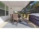 Outdoor dining area on covered patio with furniture, lighting, and backyard view at 1011 Nours Cir, Lawrenceville, GA 30045
