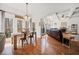 Open floor plan of dining area into living room with tray ceilings, fireplace and hardwood floors at 1208 Cotton Gin Dr, Powder Springs, GA 30127