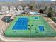 Aerial view of community's tennis court, pool and playground nestled amongst the homes at 5160 Bucknell Trce, Cumming, GA 30028