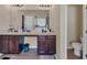 Well-lit bathroom with dual sinks, granite countertops, and modern fixtures at 5160 Bucknell Trce, Cumming, GA 30028