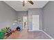 Spare bedroom featuring neutral walls, a ceiling fan and play area with shelving at 5160 Bucknell Trce, Cumming, GA 30028