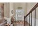 Bright foyer featuring hardwood floors, a decorative rug, and a white front door with glass panels at 5160 Bucknell Trce, Cumming, GA 30028