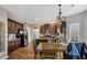 Eat-in kitchen features dark cabinets, granite countertops, stainless steel appliances, and a wood dining table at 5160 Bucknell Trce, Cumming, GA 30028