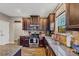 Kitchen features dark cabinets, granite countertops, and stainless steel appliances at 5160 Bucknell Trce, Cumming, GA 30028
