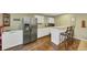Basement kitchenette featuring stainless steel appliances, granite counters, and bar-style seating at 5160 Bucknell Trce, Cumming, GA 30028