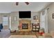 Cozy living room with hardwood floors, a stone fireplace, and ample natural light at 5160 Bucknell Trce, Cumming, GA 30028
