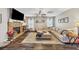 Spacious living room with stone fireplace, hardwood floors, and a comfortable sectional sofa at 5160 Bucknell Trce, Cumming, GA 30028