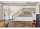 Open-concept living room showcasing hardwood floors, a staircase, and elegant wainscoting at 5160 Bucknell Trce, Cumming, GA 30028