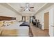 Large main bedroom with sitting area, bedroom set, ensuite office and neutral decor at 5160 Bucknell Trce, Cumming, GA 30028
