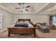 Spacious main bedroom featuring a large bed, ceiling fan, and living area at 5160 Bucknell Trce, Cumming, GA 30028