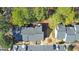 Aerial view of townhouses with landscaped grounds, ample parking, and mature trees at 66 Goldrush Ne Cir, Atlanta, GA 30328