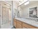Bright bathroom with a granite countertop vanity, large mirror, and a shower-tub combo at 66 Goldrush Ne Cir, Atlanta, GA 30328