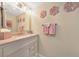 Bathroom with an updated vanity, granite countertop, framed mirror, and decorative elements at 66 Goldrush Ne Cir, Atlanta, GA 30328