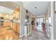 Bright hallway with wood floors and decorative cabinet, leading to the kitchen and living room at 66 Goldrush Ne Cir, Atlanta, GA 30328